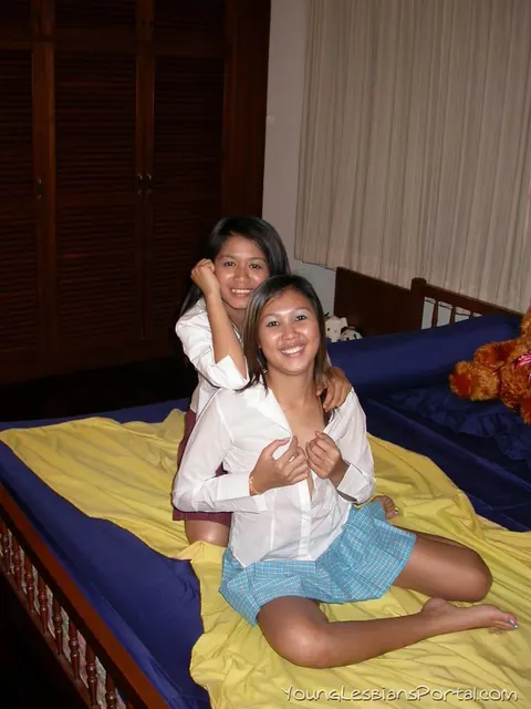 Asian Brunettes Kiss and Finger in Skirts on the Bed – photo 3 of 16