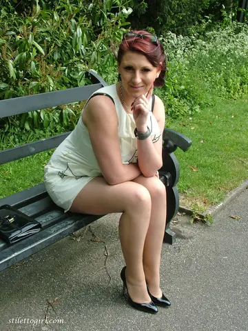 Demi Scott – Redhead MILF Shows Off Stilettos and Curves on the Park Bench