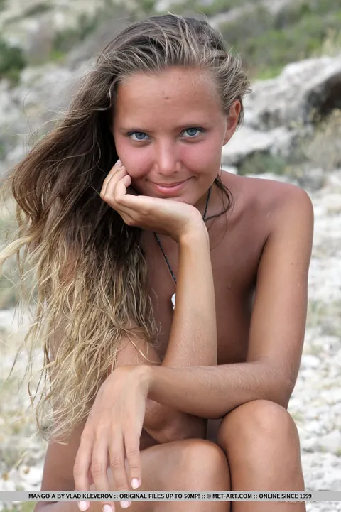Mango A: Blonde in a Skirt Strips and Spreads on a Rocky Beach – photo 10 of 18