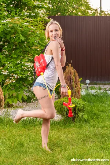 Slim European Blonde Strips Out of Her Shorts Outdoors