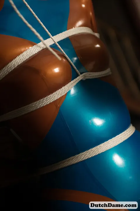 Woman Bound in Intricate Rope While Wearing a Latex Suit – photo 8 of 16