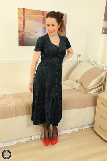 Busty European MILF Strips to Stockings and Spreads on the Sofa
