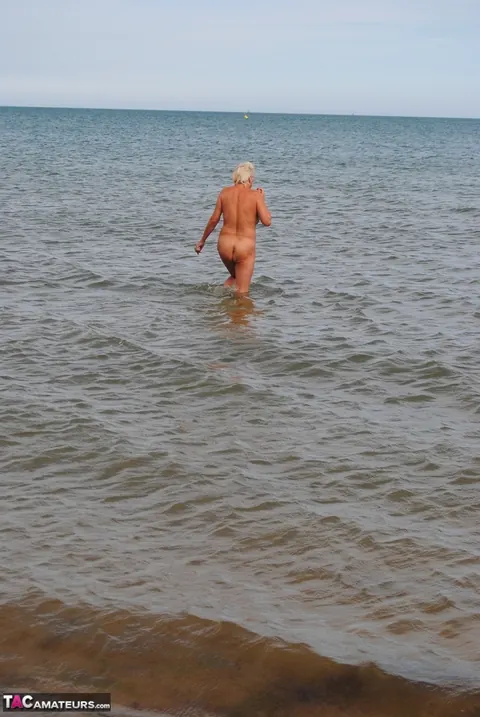 Slim Mature Blonde Strips Out of Her Shorts on the Beach – photo 8 of 20