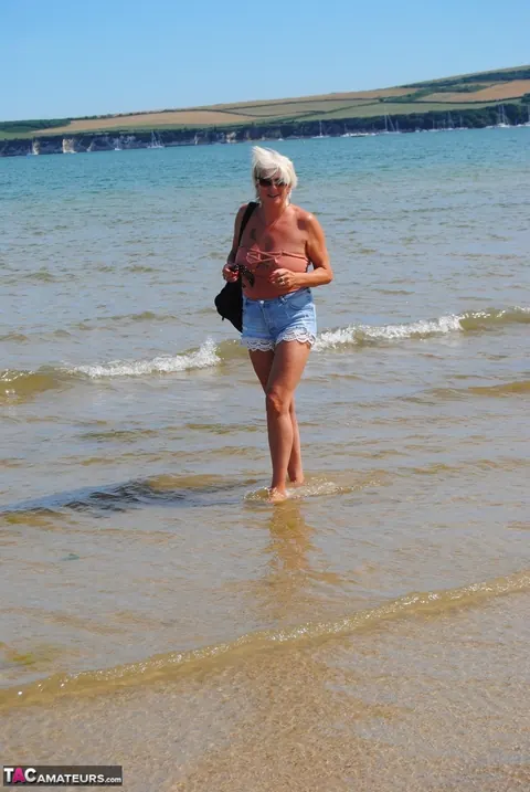 Slim Mature Blonde Strips Out of Her Shorts on the Beach – photo 7 of 20