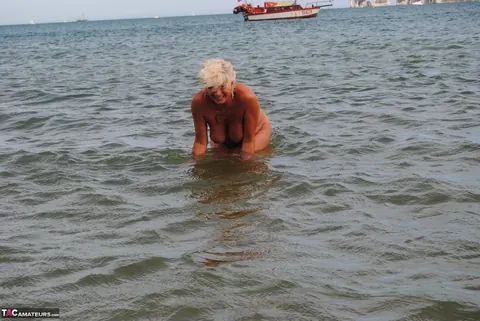 Slim Mature Blonde Strips Out of Her Shorts on the Beach – photo 1 of 20