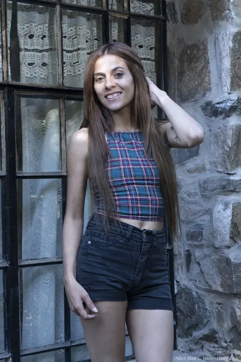 Alice Mad: Slim Brunette Pulls Shorts Aside to Show Her Hairy Pussy Outdoors – photo 1 of 21