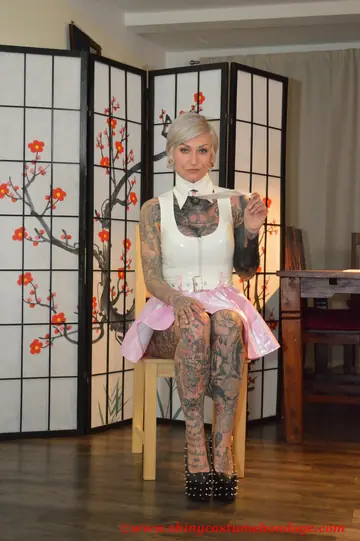 Tattooed Platinum Blonde Shows Off Her Latex Dress and Heels Under Raincoat