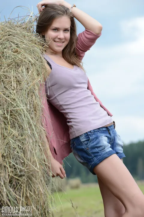 Rumba: Brunette Squats in Shorts and Spreads on Hay – photo 3 of 20