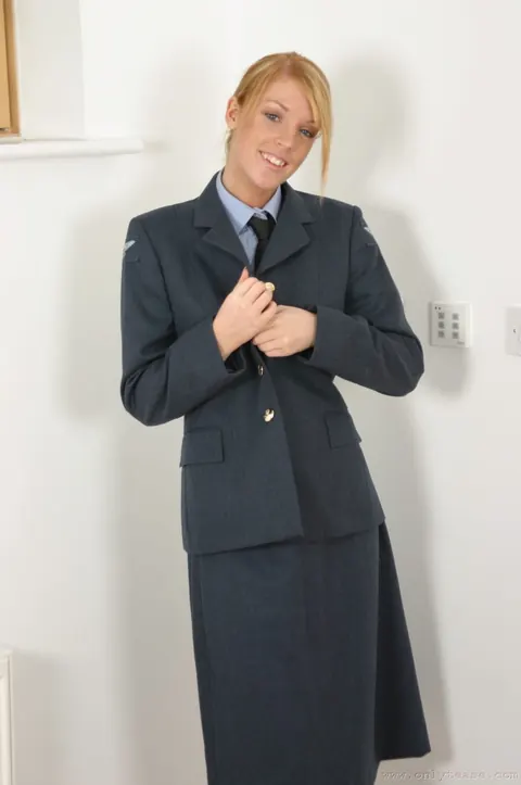 Woman with Enhanced Tits Strips Out of Her Uniform and Stockings – photo 9 of 21
