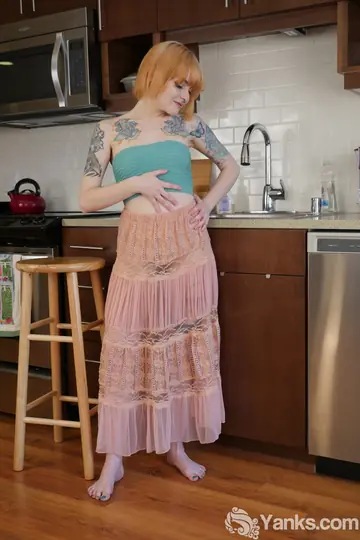 Tattooed Redhead in a Skirt Fingers and Toys Herself in the Kitchen