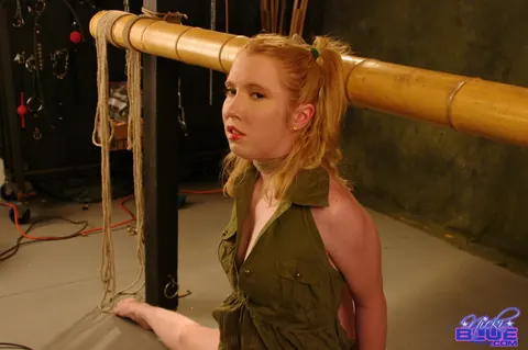 Nicki Blue: Pale Redhead in a Skirt Bound to a Bamboo Bar – photo 6 of 15