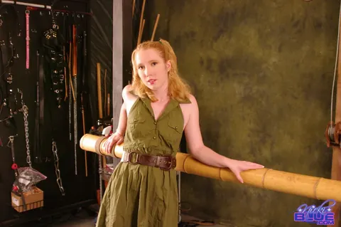 Nicki Blue: Pale Redhead in a Skirt Bound to a Bamboo Bar – photo 1 of 15