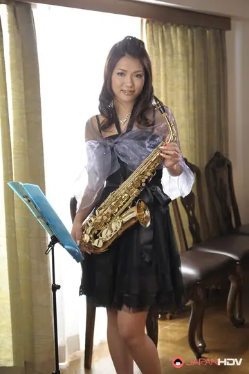 Japanese Brunette with Natural Tits Poses in a Skirt and Pantyhose