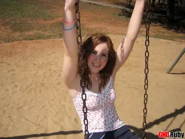 Redhead PAWG Crosses Her Legs on a Swing in a Public Park