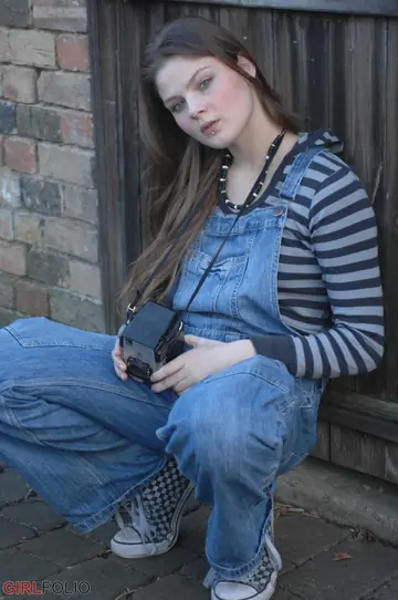 Woman Strips Out of Her Jeans Nude by a Window Outdoors