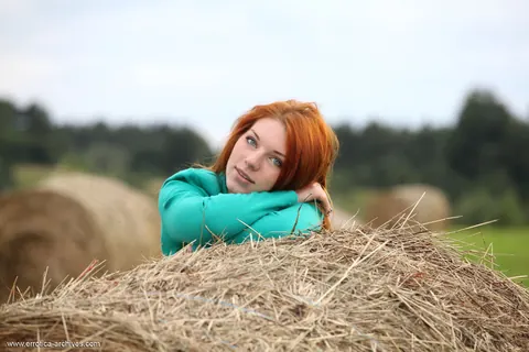 Thick Redhead Spreads Her Pussy on a Round Hay Bale – photo 1 of 16
