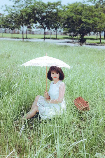 Asian Woman Strips Out of Her Dress in a Forest Meadow