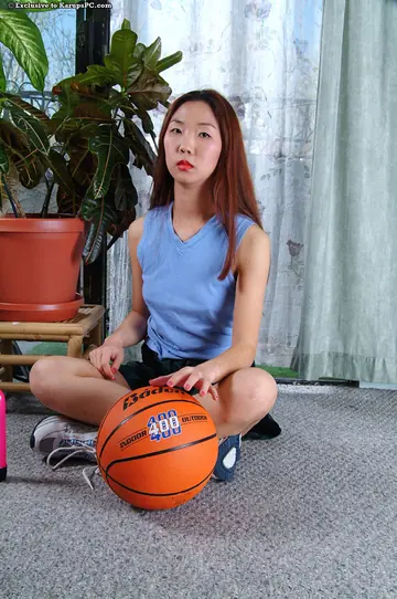 Asian Brunette Strips Out of Her Shorts with a Basketball