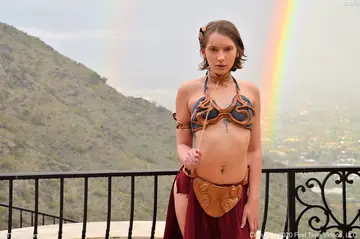 Short-Haired Brunette in Lingerie and Costume Bares Her Pussy Outdoors