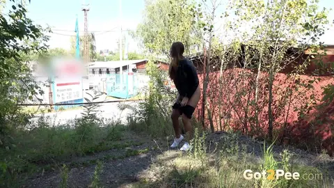 Woman in Leather Shorts Squats and Pees Outdoors – photo 14 of 15