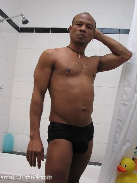 Bodybuilder Strokes His Uncut Cock in the Bathroom – photo 10 of 21