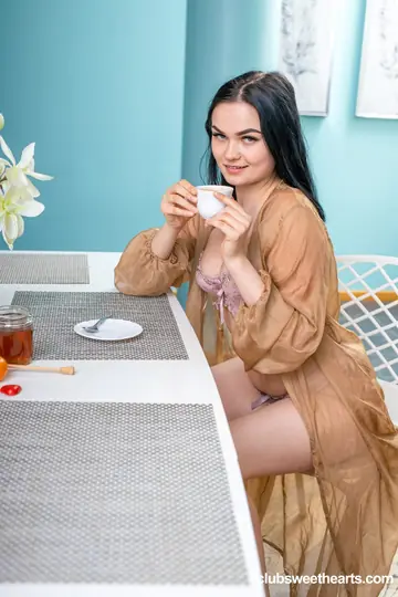 European Woman Undresses and Poses Nude with Hips Turned