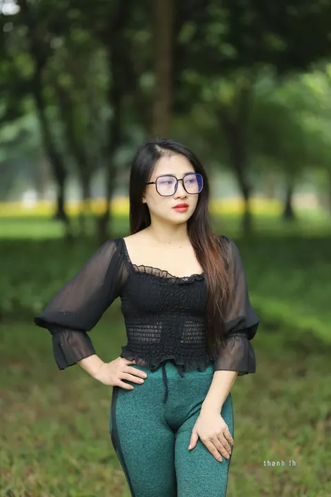 Asian Brunette with Big Tits Poses in a Top and Glasses Outdoors – photo 18 of 21