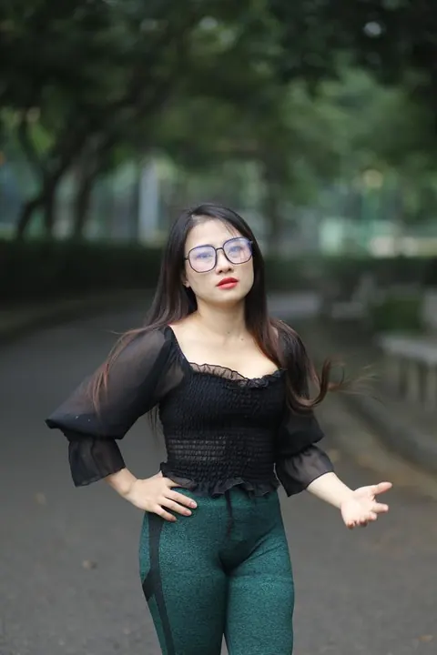 Asian Brunette with Big Tits Poses in a Top and Glasses Outdoors – photo 15 of 21