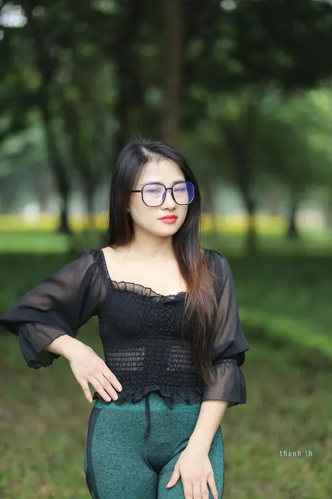 Asian Brunette with Big Tits Poses in a Top and Glasses Outdoors – photo 17 of 21
