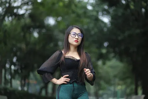Asian Brunette with Big Tits Poses in a Top and Glasses Outdoors – photo 13 of 21
