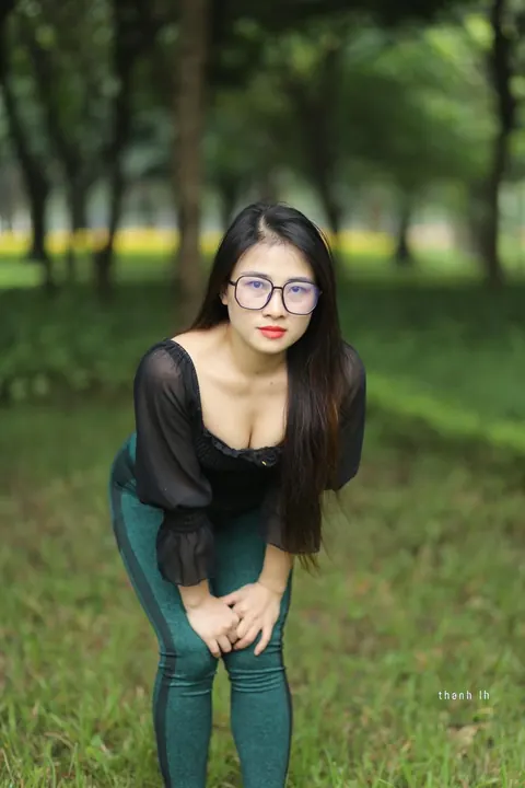 Asian Brunette with Big Tits Poses in a Top and Glasses Outdoors – photo 20 of 21