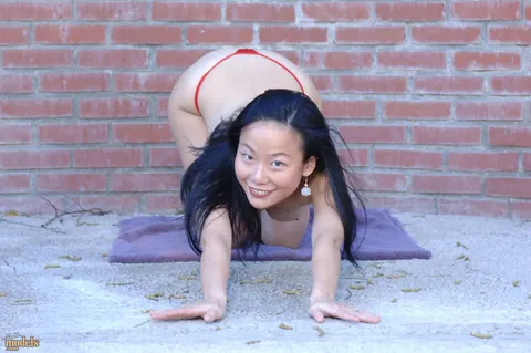 Niya Yu: Asian MILF Strips Nude Outdoors by a Brick Wall – photo 10 of 16