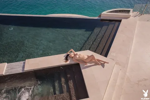 Busty Babe Strips Out of Her Bikini by the Pool – photo 15 of 21