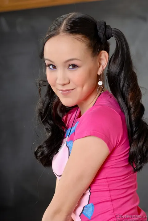 Amai Liu: Skinny Asian Brunette in Pigtails Pulls Down Her Shorts to Bare Her Ass – photo 6 of 15