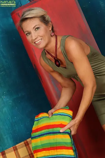 Mature Blonde in a Skirt Pulls Her Panties Aside and Fingers Her Hairy Pussy