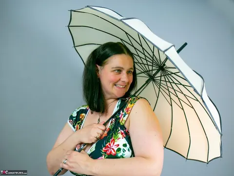 Mature Curvy Woman Strips Out of Her Skirt While Holding Umbrella – photo 15 of 16
