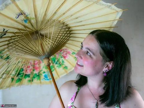 Mature Curvy Woman Strips Out of Her Skirt While Holding Umbrella – photo 2 of 16
