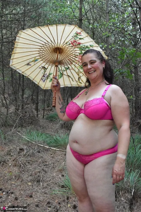 Mature Chubby Woman in a Bikini Strips Nude in a Forest Clearing – photo 15 of 16