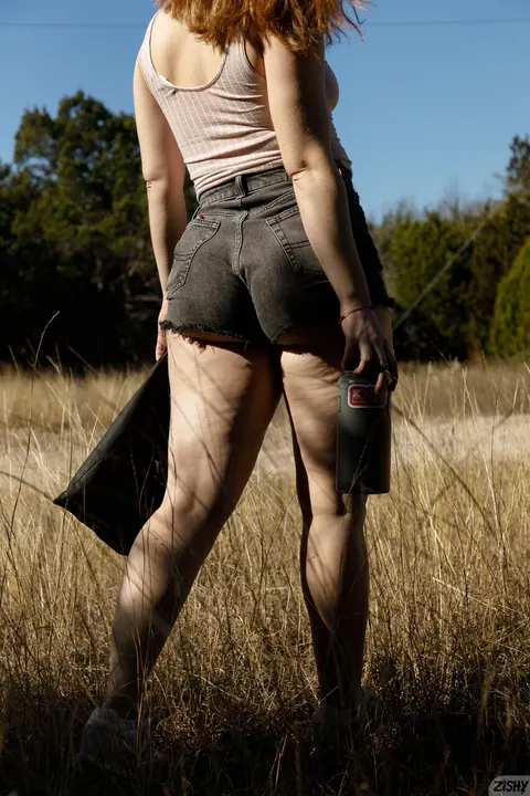 Thick Woman Poses in Booty Shorts and Shows Her Legs – photo 10 of 13