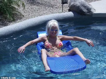 Slim Blonde Shows Her Huge Fake Tits and Tattoo by the Pool