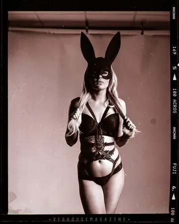 Woman in Lingerie and Bunny Ears Poses for the Camera