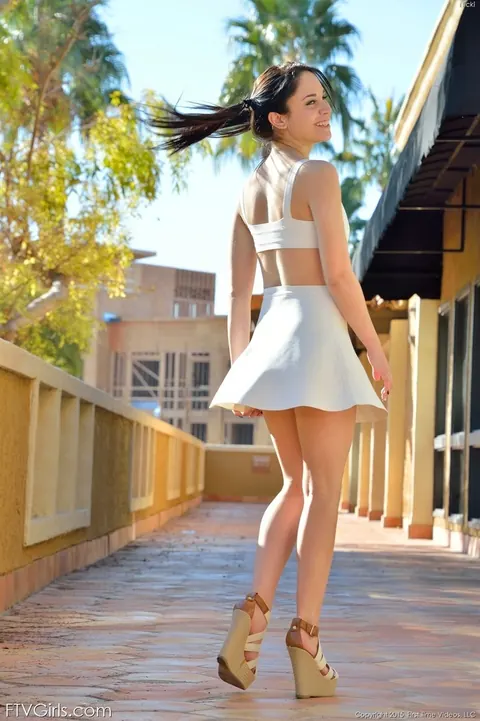 Flexible Woman in a Skirt and Heels Strips Nude Outdoors – photo 3 of 15