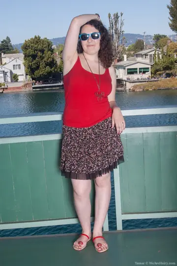 Brunette BBW Strips Out of Her Skirt on a Balcony Overlooking the River