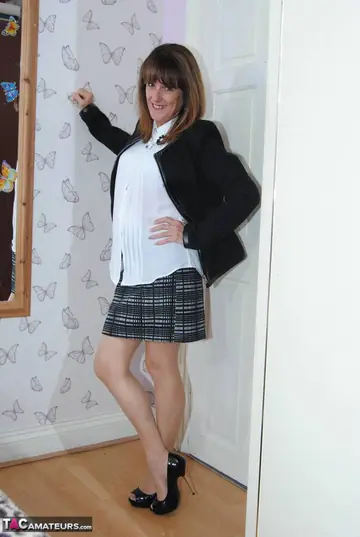 Mature British Brunette Strips Out of Her Skirt in the Bedroom