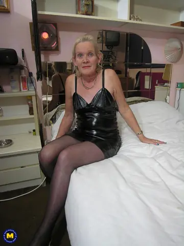 Mature Blonde in a Latex Dress and Stockings Masturbates with a Dildo
