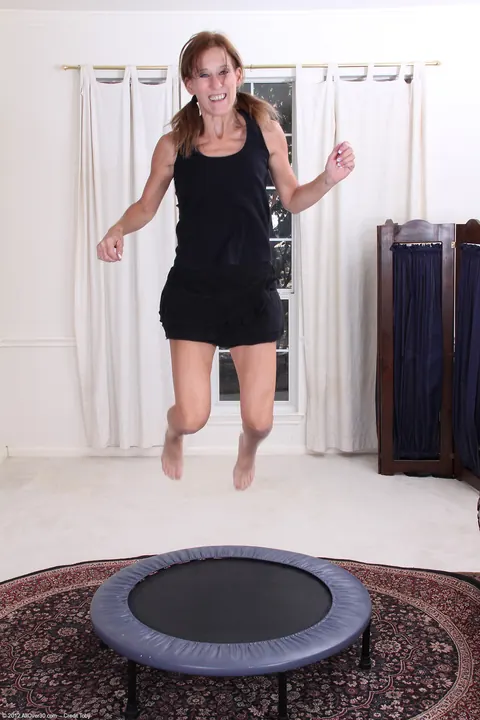 Jay Dee: Tall Redhead MILF Undresses and Fingers Her Shaved Pussy on a Trampoline – photo 2 of 20