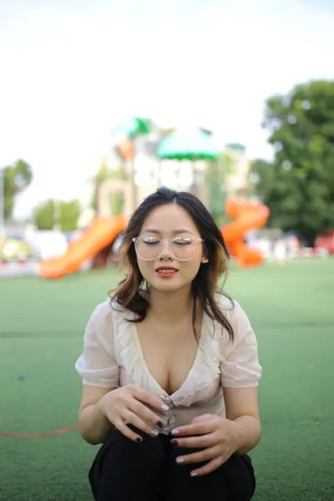 Asian Brunette in Glasses Poses Playfully Outdoors – photo 20 of 21