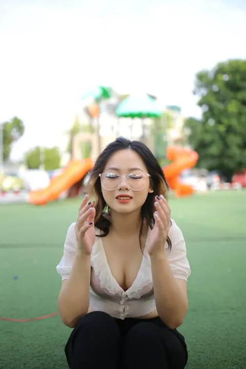 Asian Brunette in Glasses Poses Playfully Outdoors – photo 19 of 21