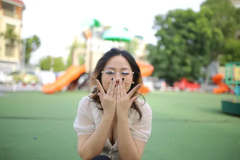 Asian Brunette in Glasses Poses Playfully Outdoors – photo 18 of 21