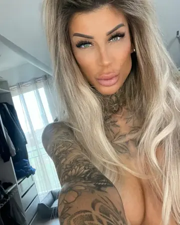 Tattooed Woman Strips and Poses Nude